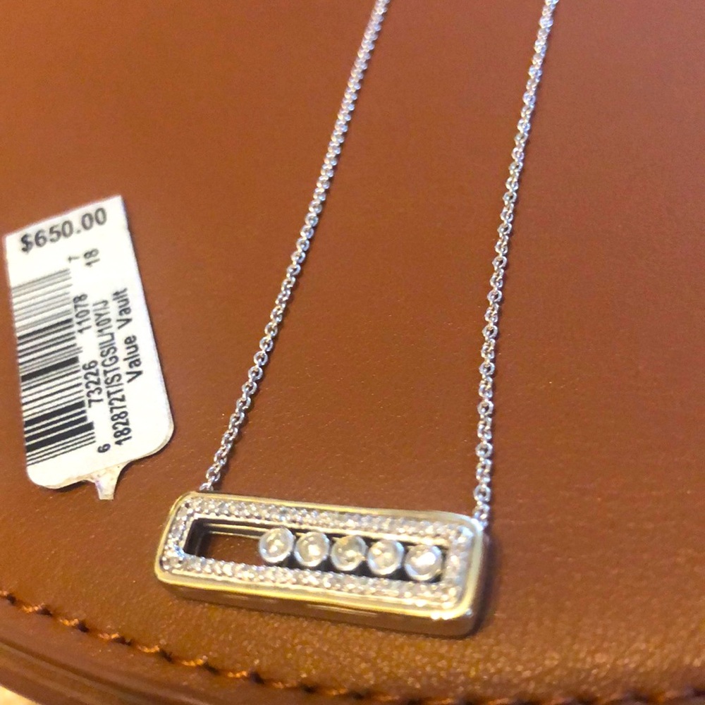 Diamond bar necklace with five moving diamonds.